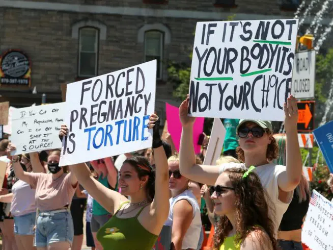 People hold signs during an abortion rights rally in Bloomsburg, Pennsylvania, on July 3, 2022.