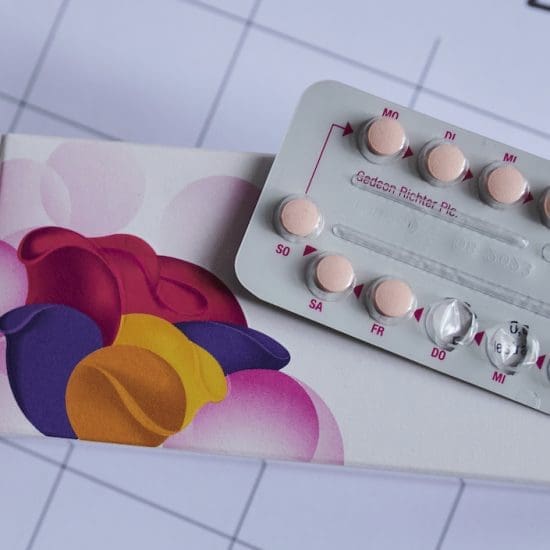 An opened package of birth control pills sits on a countertop.