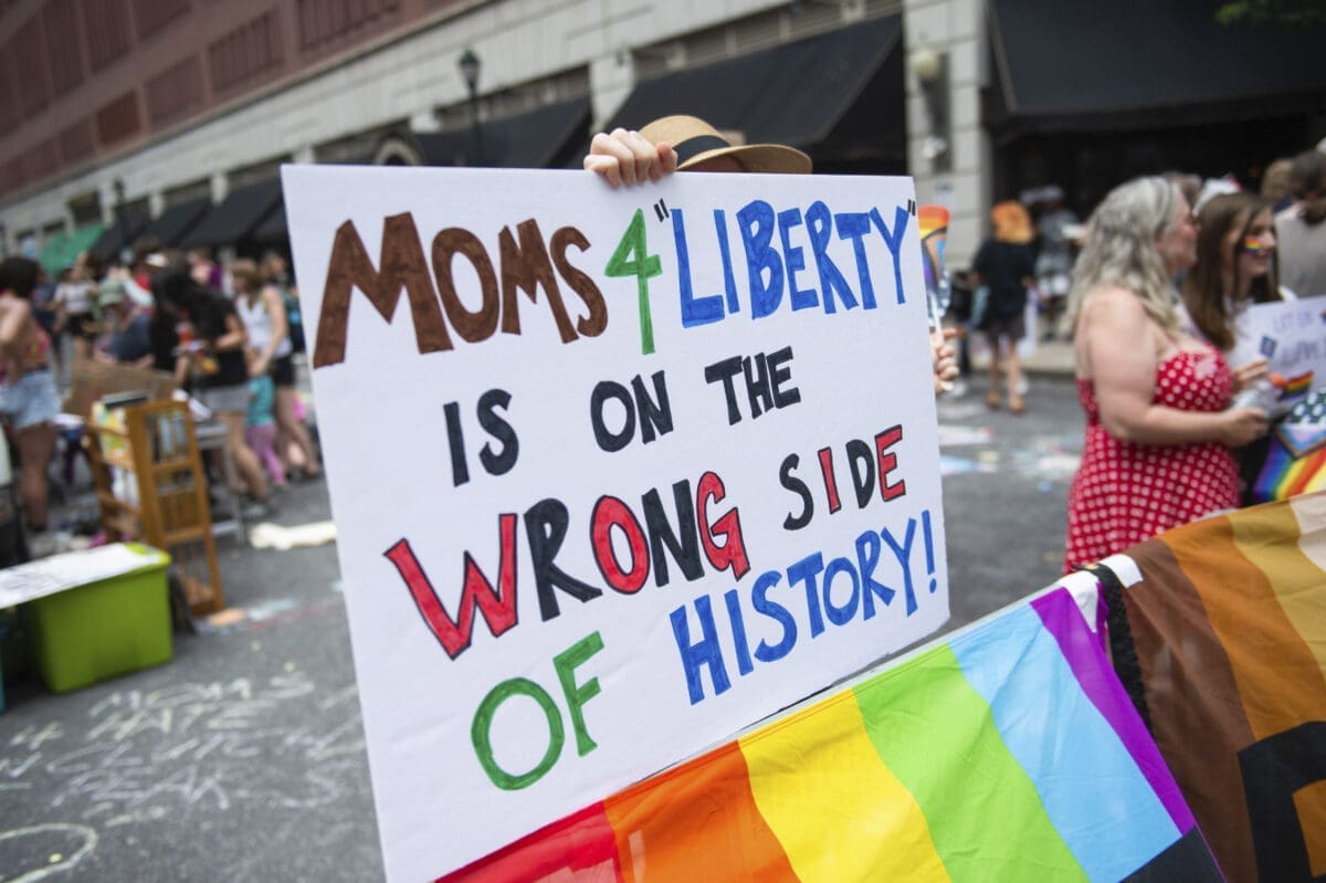 A protester holds a placard during a protest held by Philly Children's Movement against Moms For Liberty in Center City Philadelphia.