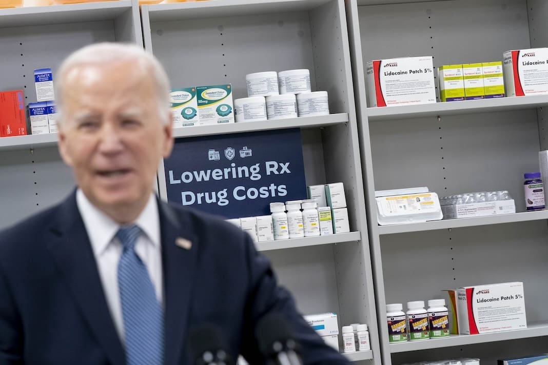 Items are displayed on shelves as President Joe Biden speaks about prescription drug costs at the National Institutes of Health in Bethesda, Md., Thursday, Dec. 14, 2023. (AP Photo/Andrew Harnik)