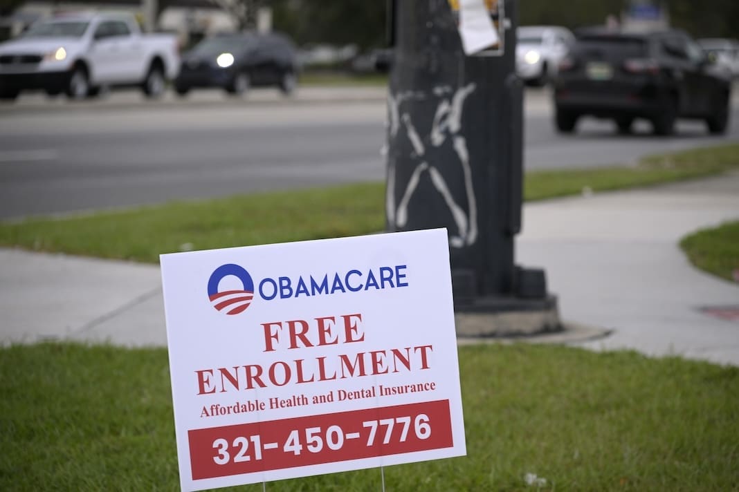 A sign advertises free enrollment for Obamacare health insurance alongside a road, Wednesday, Jan. 4, 2023, in Orlando, Fla. (Phelan M. Ebenhack via AP)